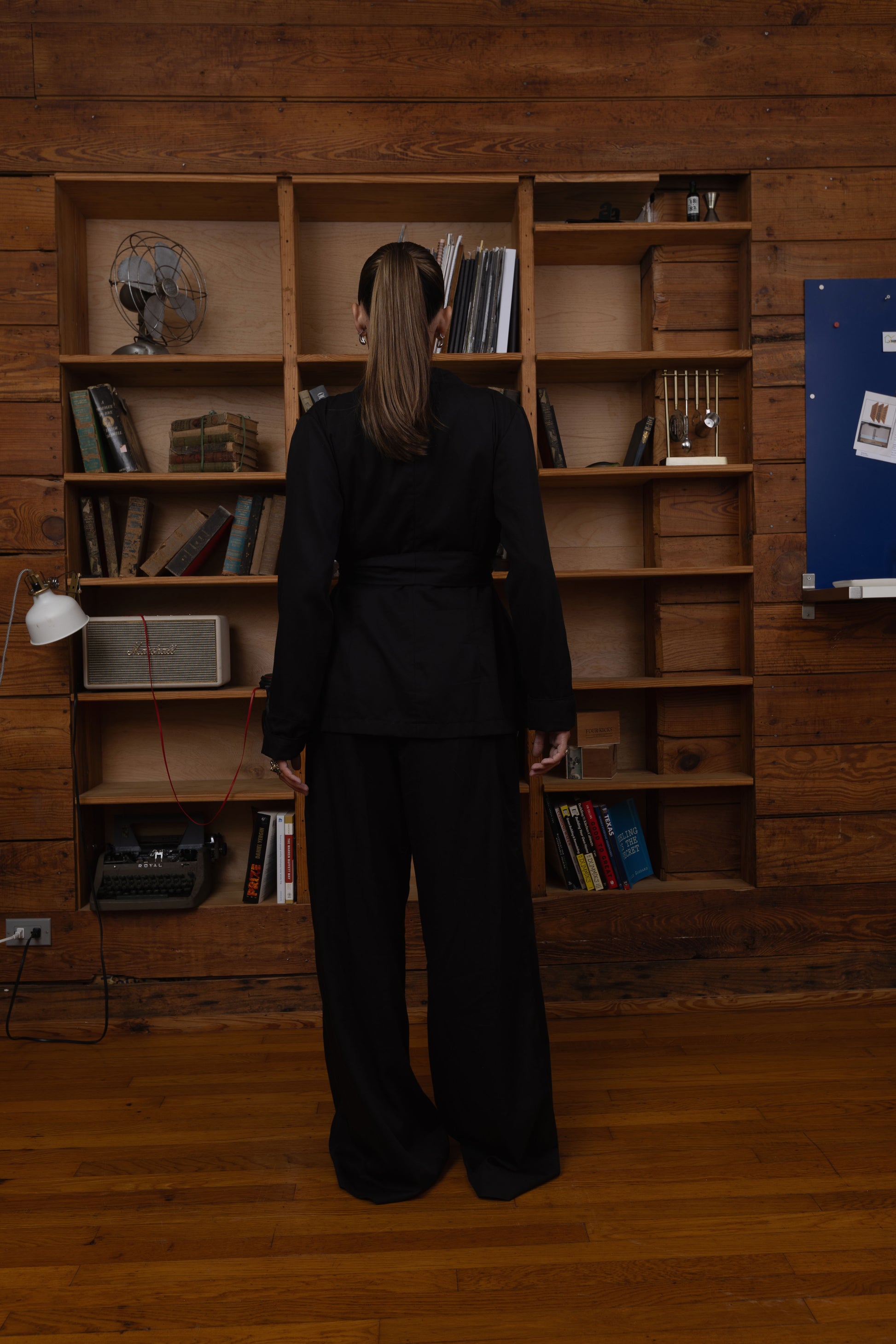Woman in a black two piece set outfit, Wide leg pants and vest